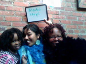 Liberated beings in boas at the MotherOurselves Bootcamp photobooth in Durham, NC!